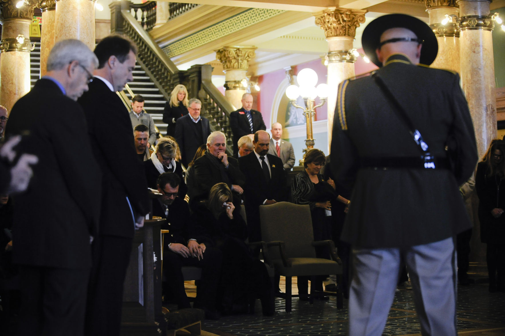Attendees hang their heads in prayer Friday morning.